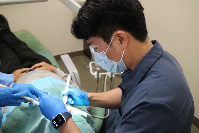 Dr. Kim providing chairside dental care at ReDefine Dentistry