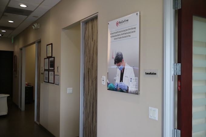 Hallway with operating room and posted credentials at ReDefine Dentistry